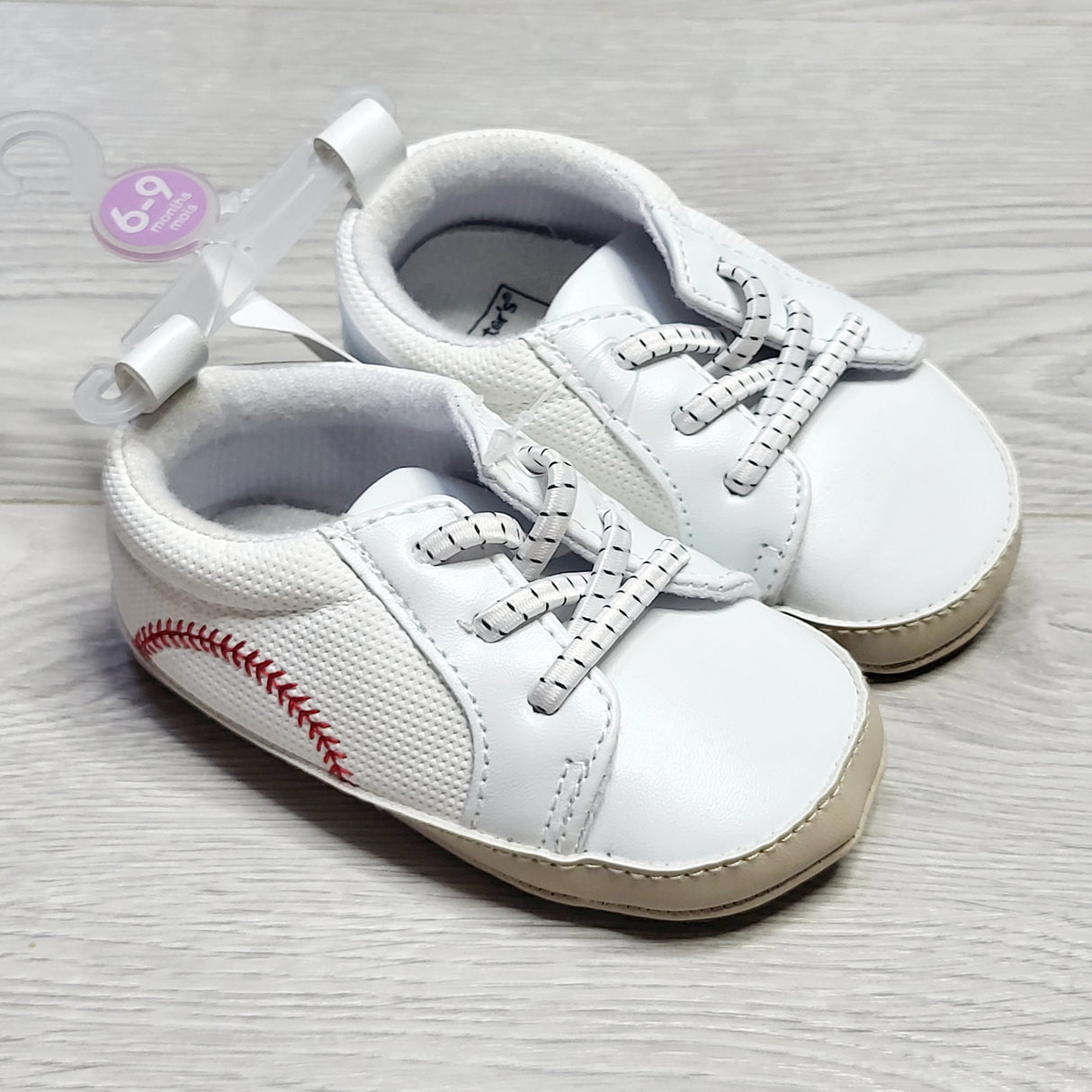 CRTH2 - NEW - Carters soft soled shoes with baseball stitching. Size 6-9 months