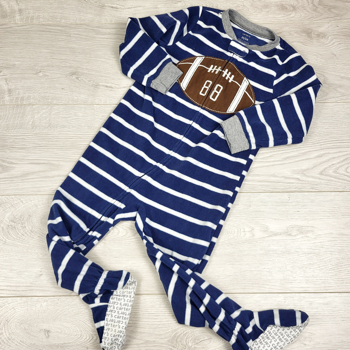 GBAR1 - Carters navy striped zippered fleece sleeper with football. Size 3T