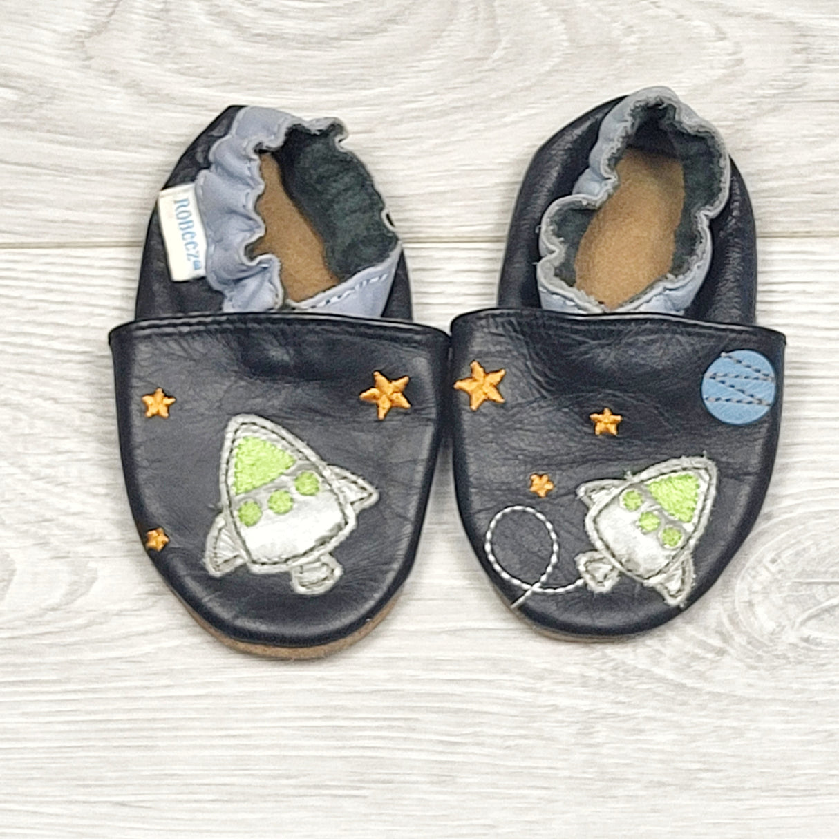 RBEN2 - Robeez black soft soled leather shoes with rockets. Size 0-6 months