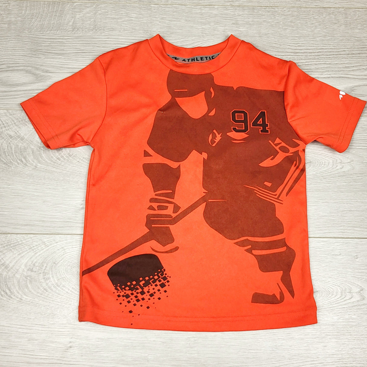 SPLT11 - Athletics Works orange quick dry t-shirt with hockey player. Size 4T