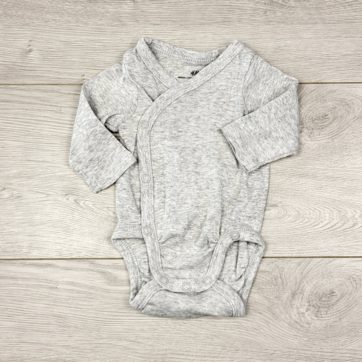 KWTT23 - H and M grey organic cotton wrap style bodysuit. Size 0-1 month