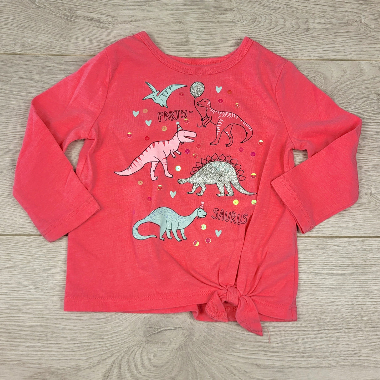 CCRT2 - Carters pink knotted top with dinosaurs. Size 9 months