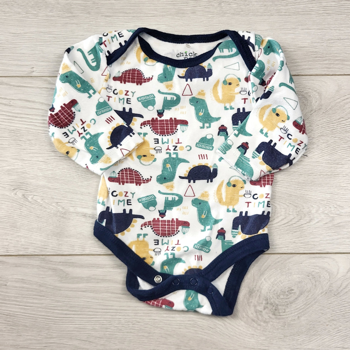 STFT22 - Chick Pea white long sleeved bodysuit with dinosaurs. Size 0-3 months