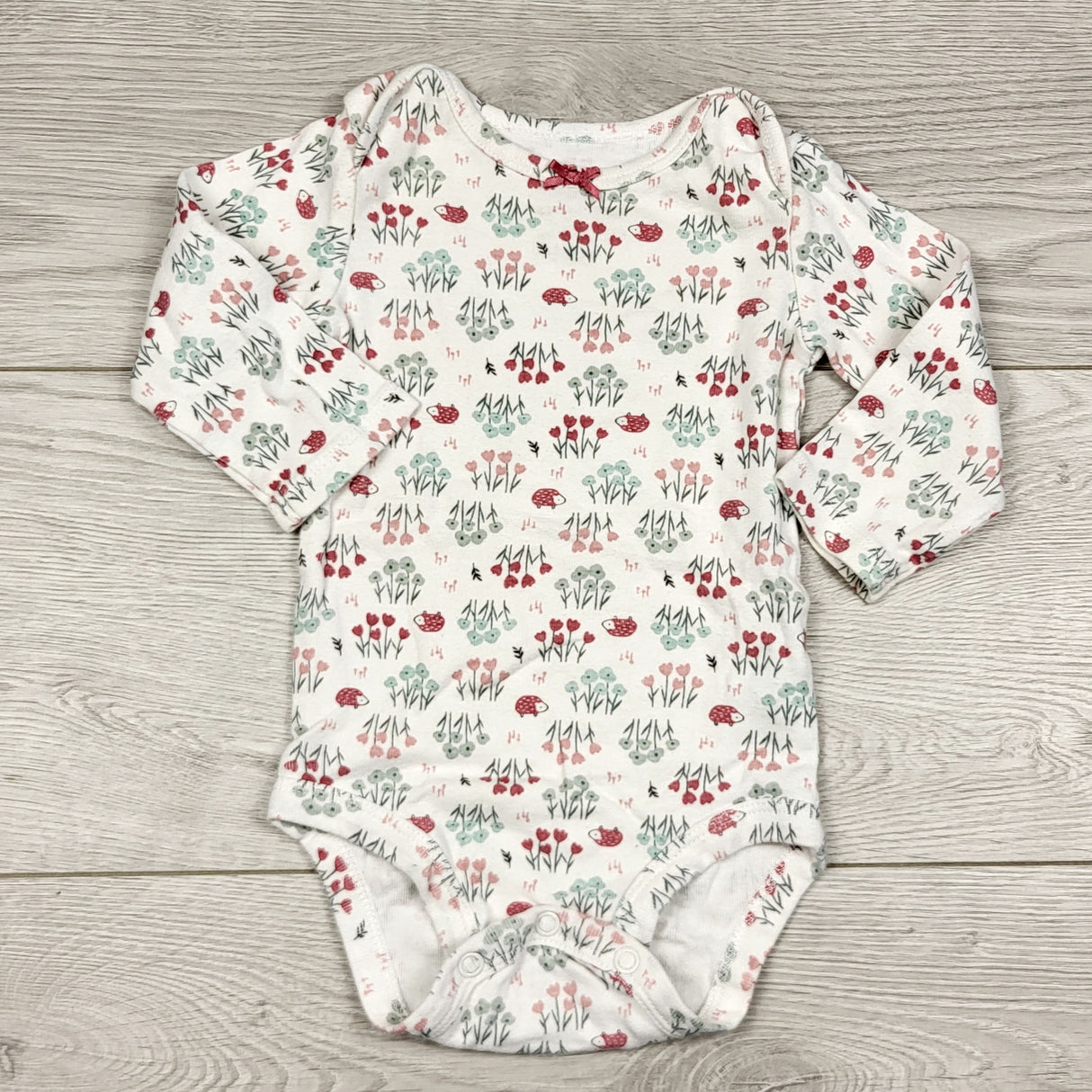 THNG11 - Child of Mine white floral print bodysuit. Size 3-6 months