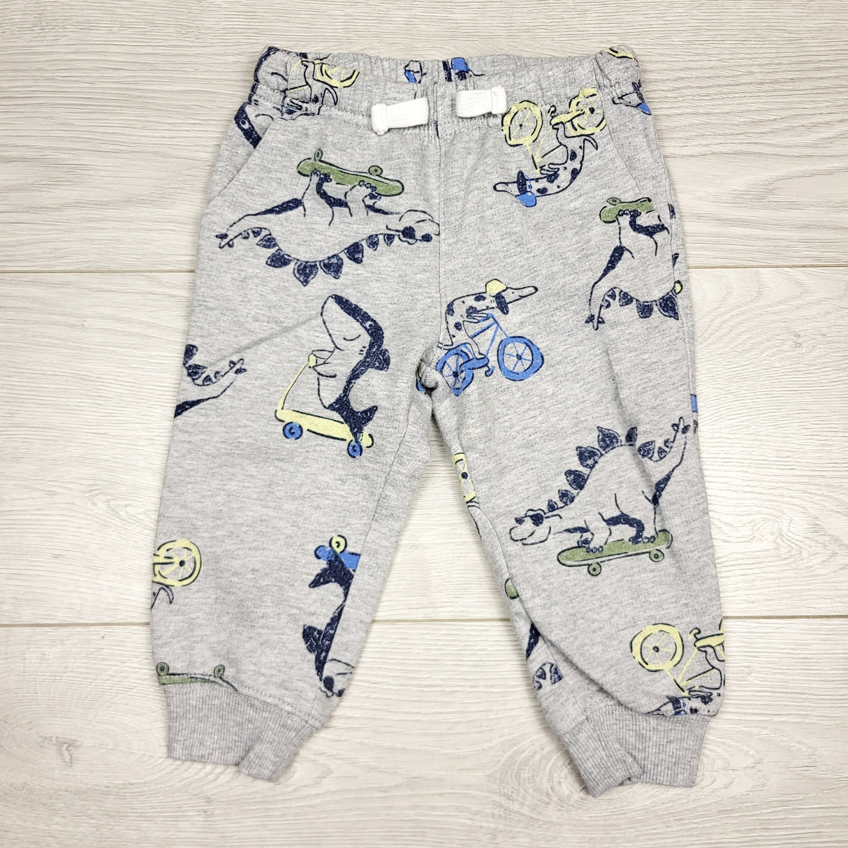 SMRSH1 - Carters grey cotton pants with skatebording dinosaurs. Size 12 months