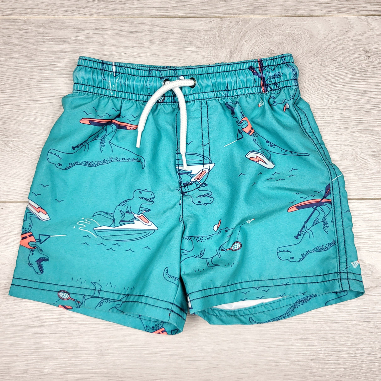 CHLV1 - Carters teal swim shorts with dinosaurs. Size 24 months