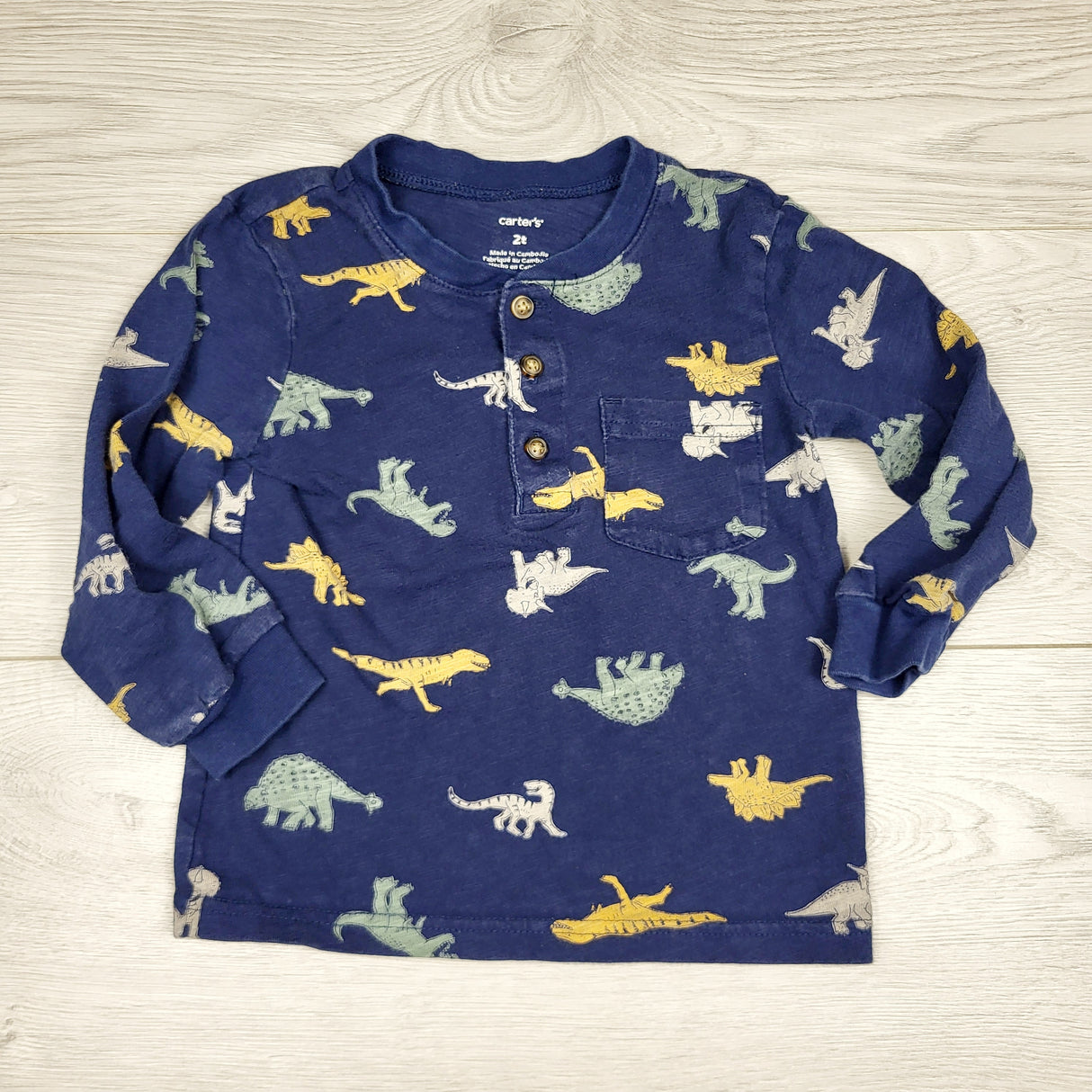 CHLV1 - Carters navy long sleeved top with dinosaurs. Size 2T