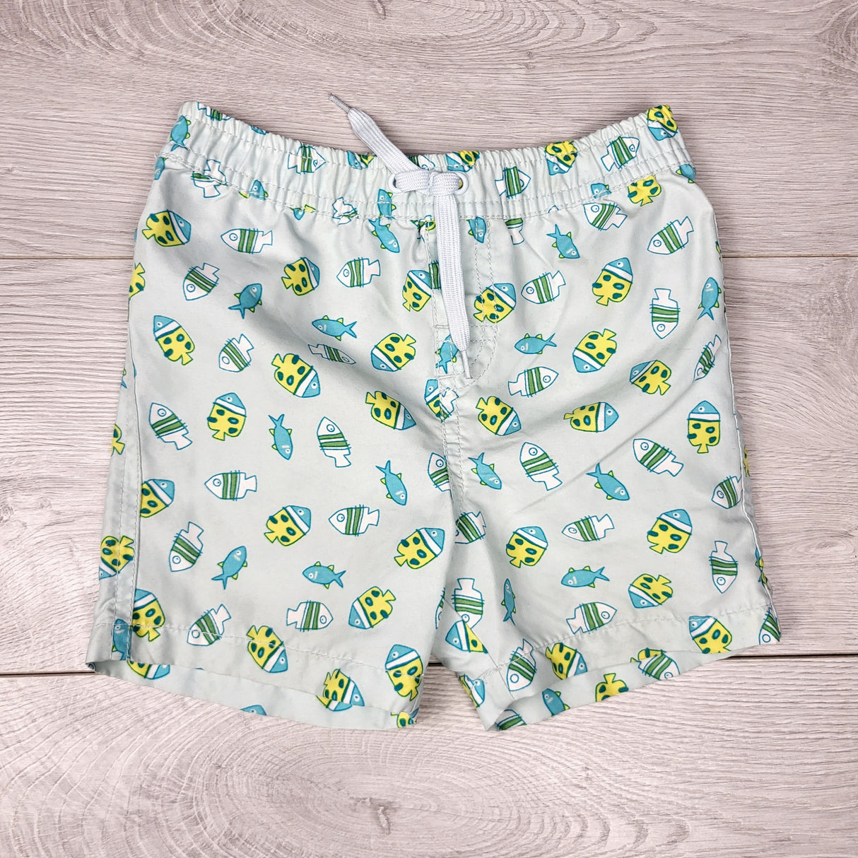 NTLL1 - Joe mint coloured board shorts with fish. Size 12-18 months