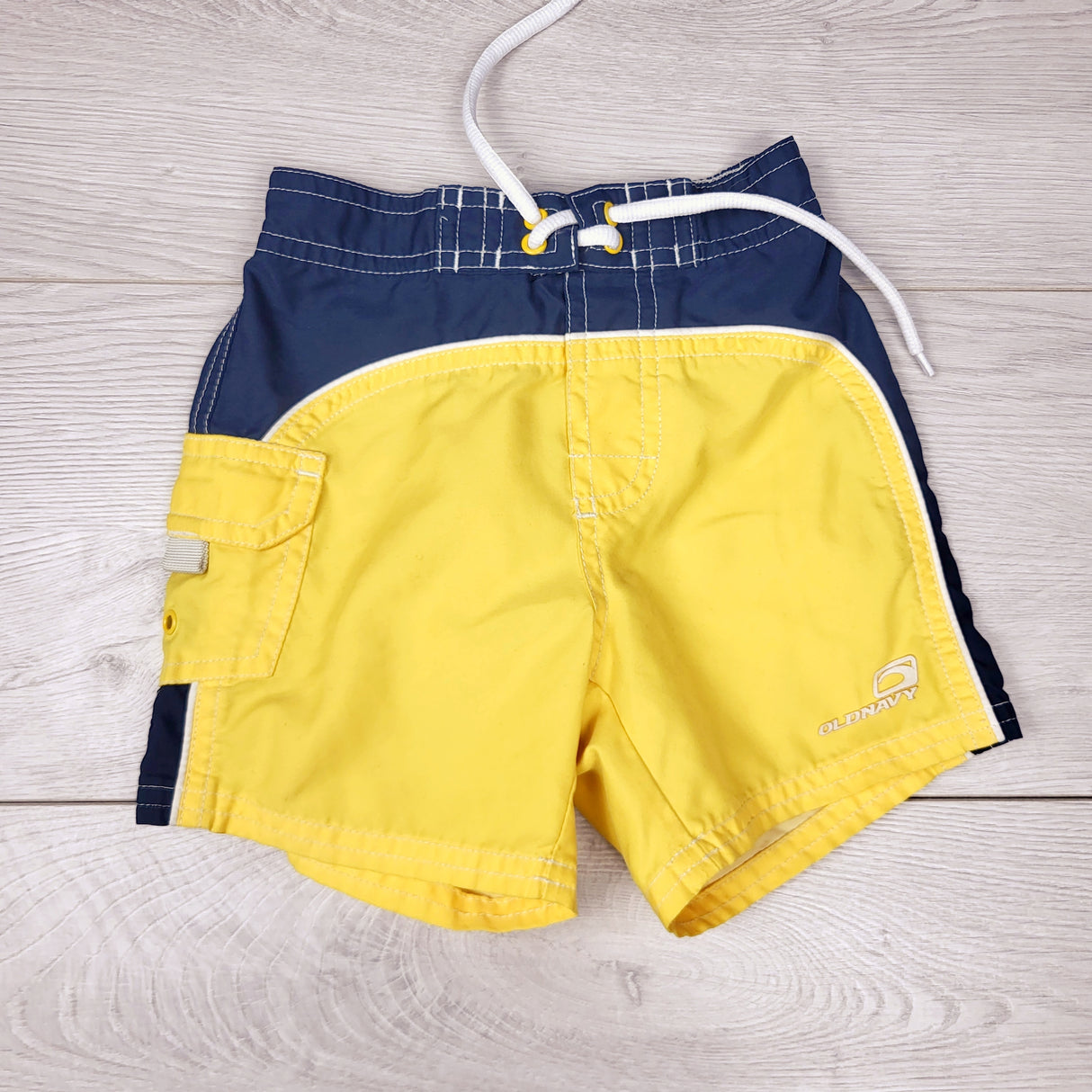 NTLL1 - Old Navy yellow and navy board shorts. Size 6-12 months