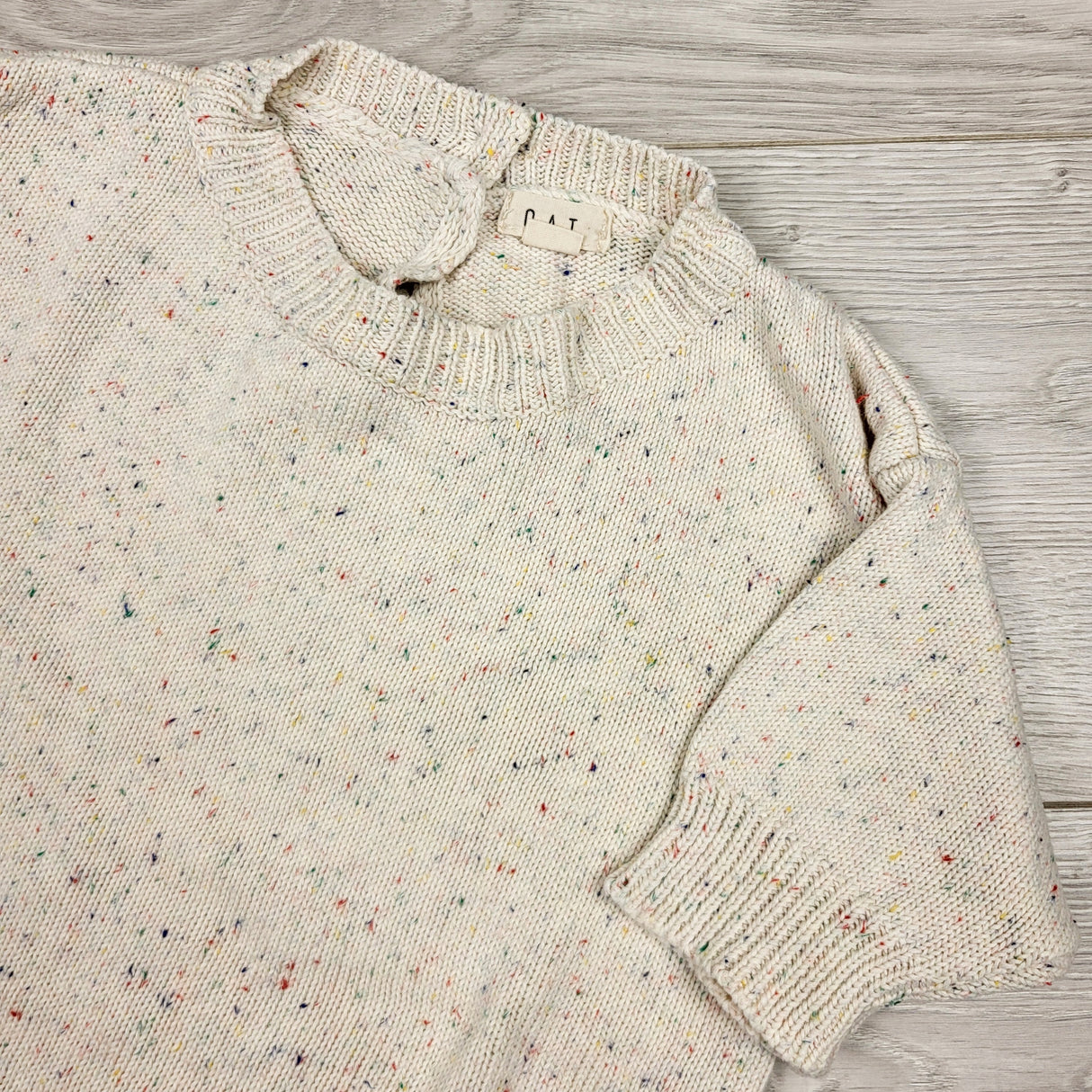 DMKY2 - Oat brand speckled sweater romper. Size 0-6 months