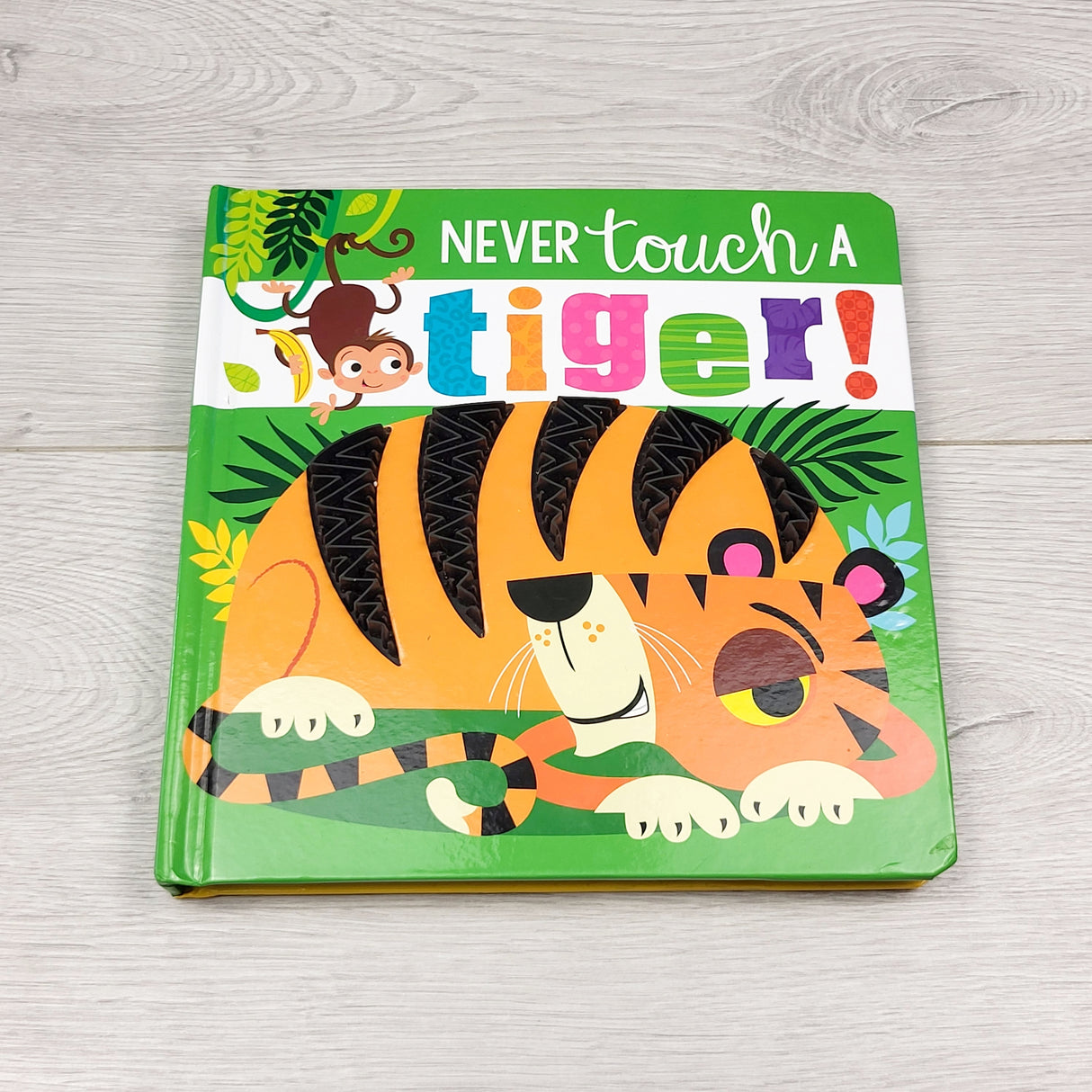 HCOL2 - Never Touch a Tiger. Touch and feel board book