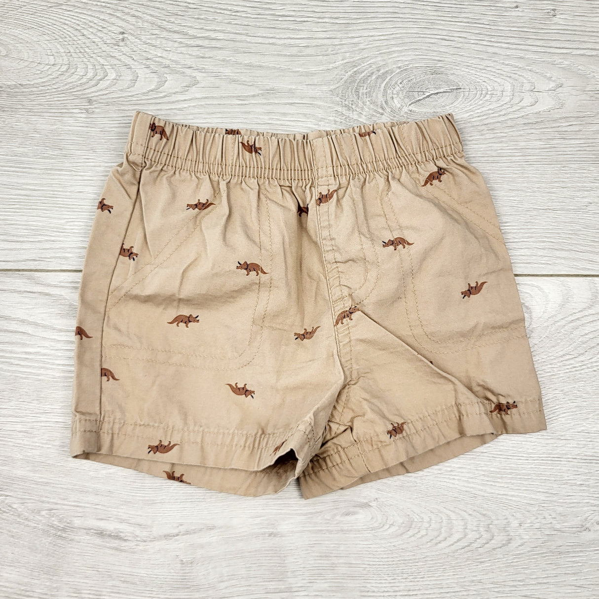 AALD1 - Carters light brown shorts with dinosaurs. Size 9 months