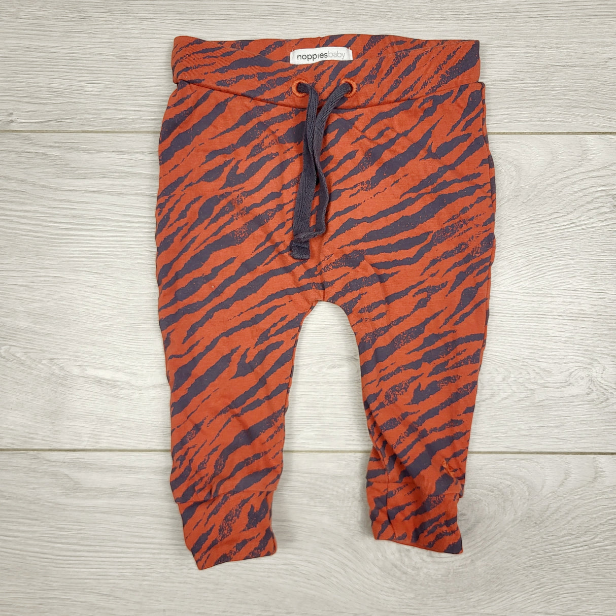 CCAM3 - Noppies orange zebra print pants. Size 0-3 months