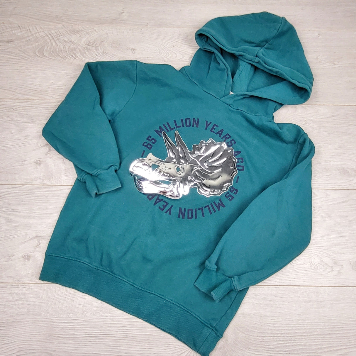 PS3 - H and M teal fleecy lined pullover hoodie with metallic dinosaur. Size 8-10 years