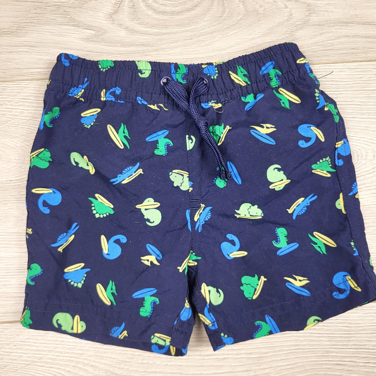 PRCH2 - First Impressions navy swim shorts with dinosaurs. Size 3-6 months