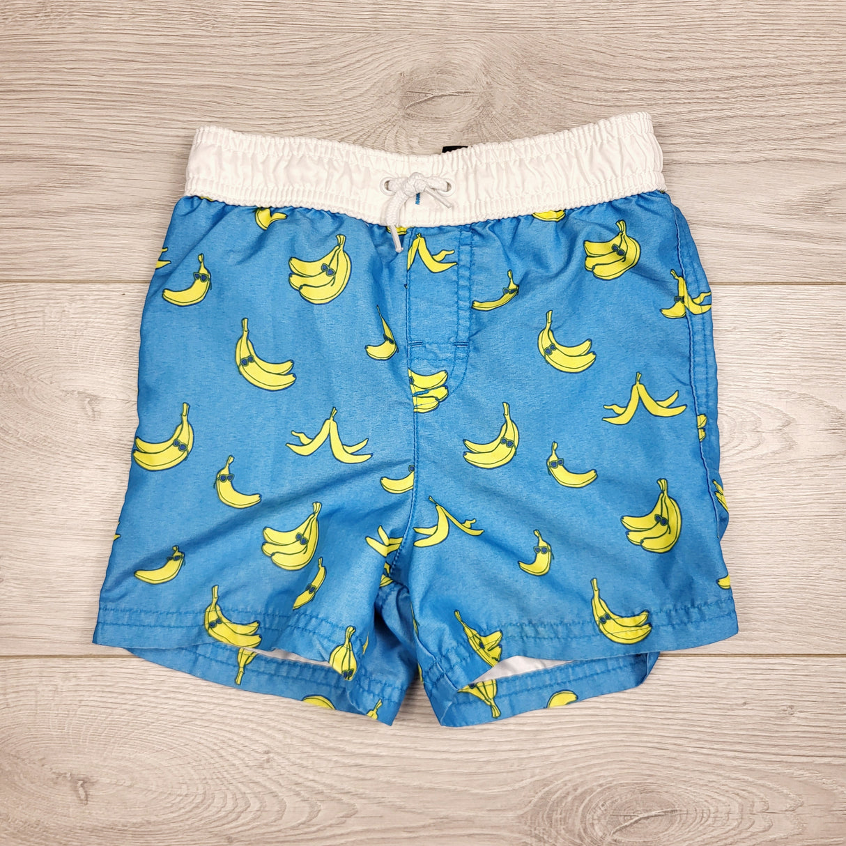 GFST1 - George blue swim shorts with bananas. Size 18-24 months