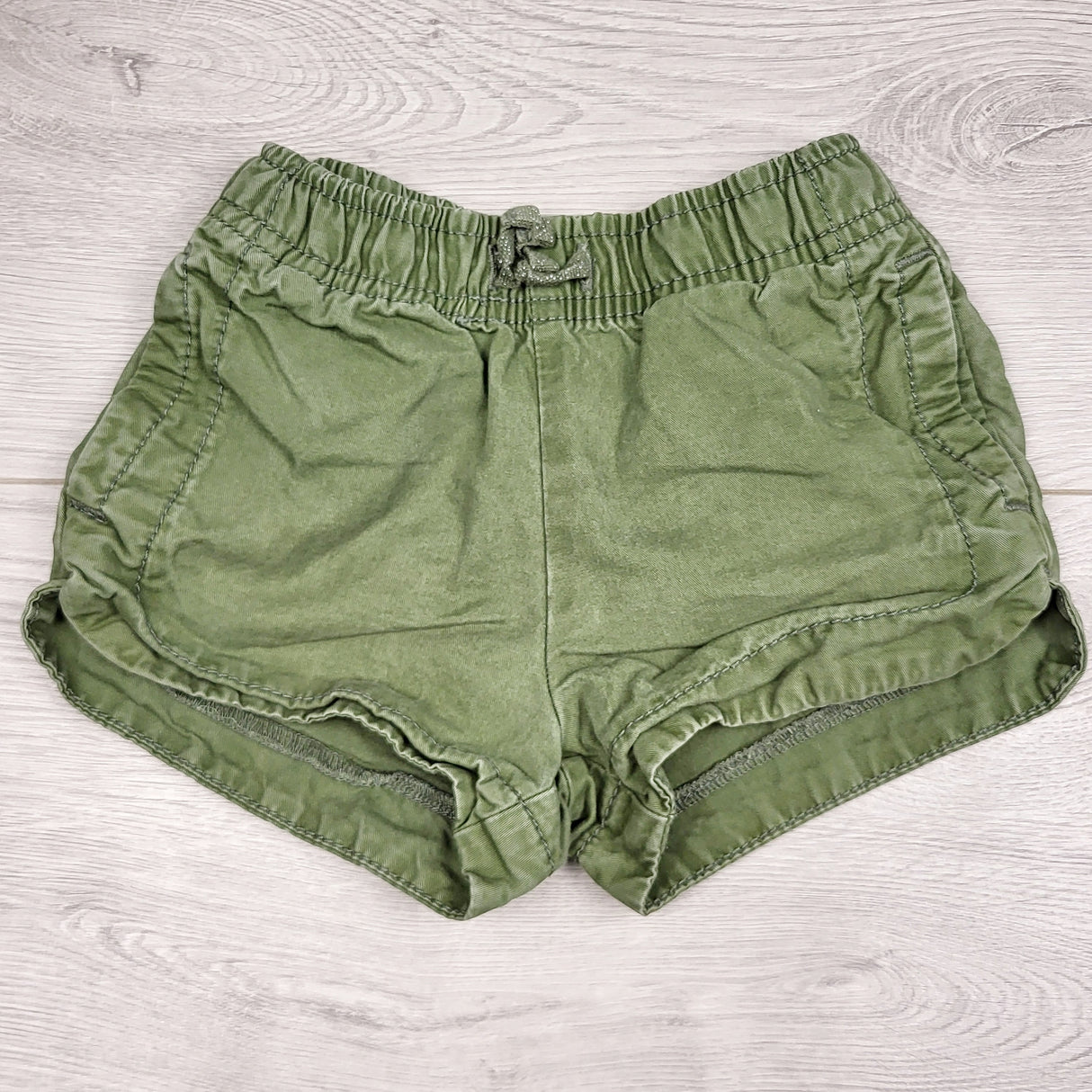 BBIN12 - Carters olive green shorts. Size 12 months