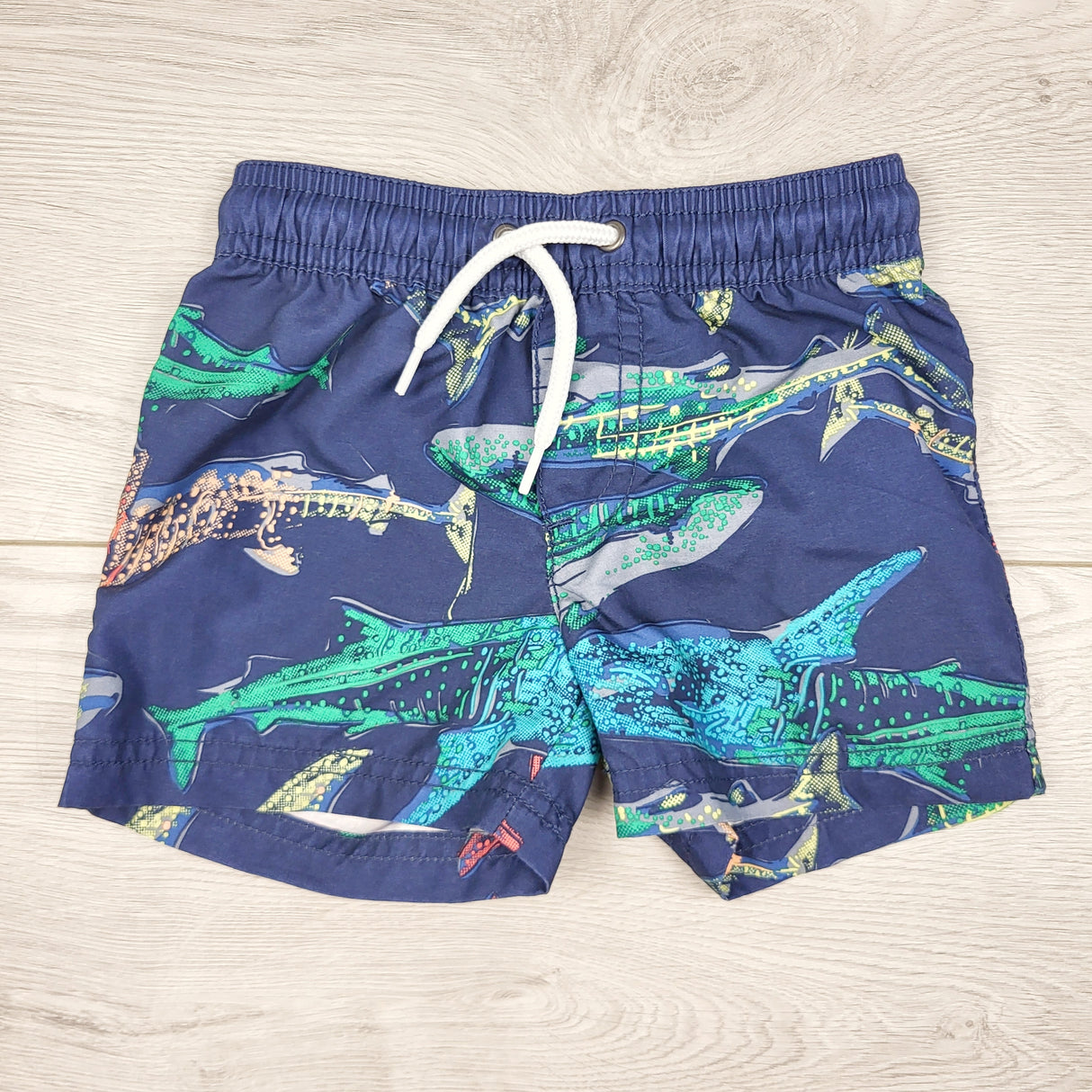 TBOW2 - Carters navy swim shorts with sharks. Size 9 months