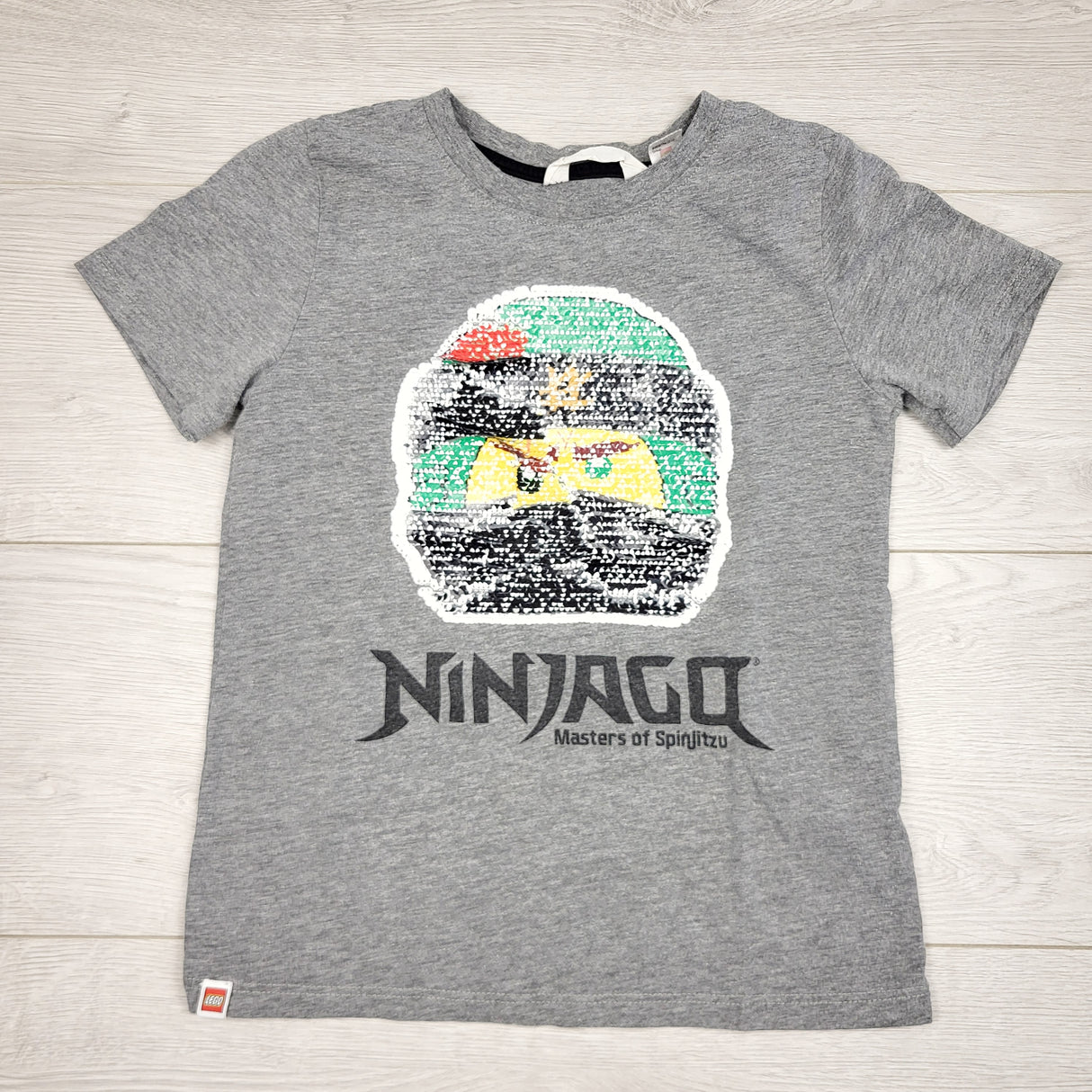 MSK1 - H and M grey Ninjago t-shirt with flip sequins. Size 6-8 Years