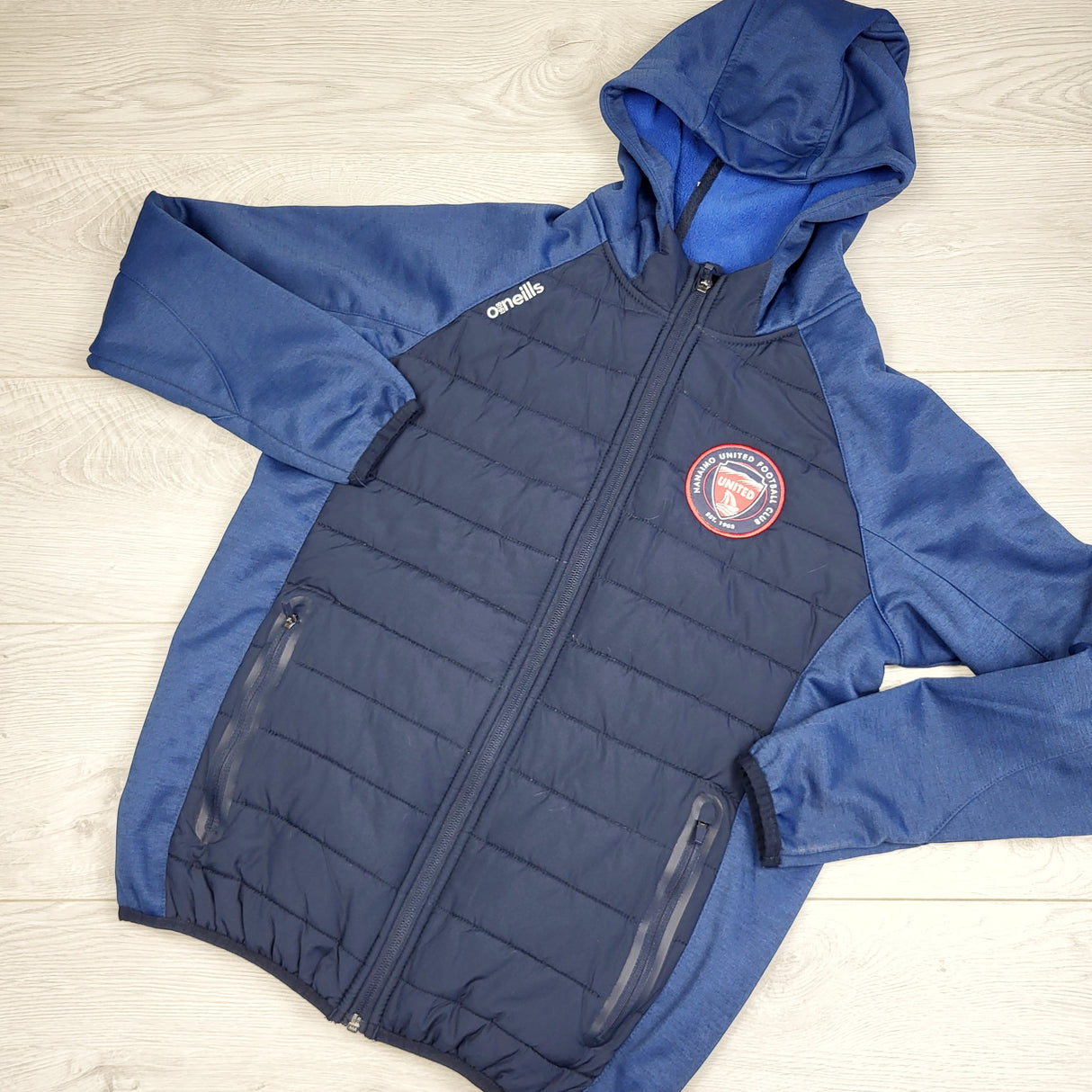 MFAIR2 - Oneill's blue padded soft shell jacket with Nanaimo soccer patch. Size 10/11