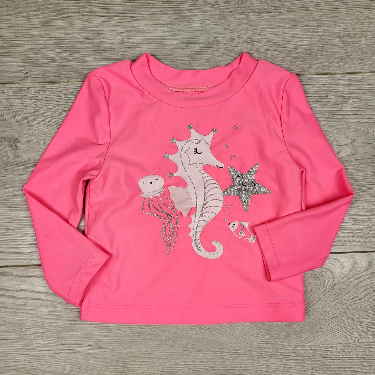KARE11 - Carters pink rash guard with ocean theme. Size 9 months