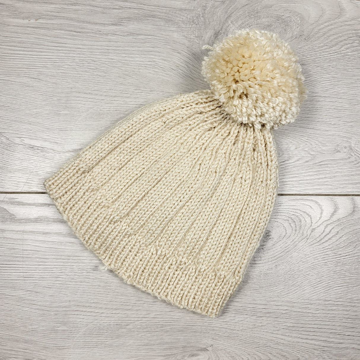SAHU1 - Beige handmade pom pom toque. One size fits all (toddler)