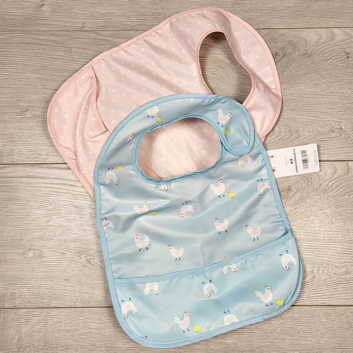 KAMG1 - NEW - Carters 2pc pink / blue plastic bibs