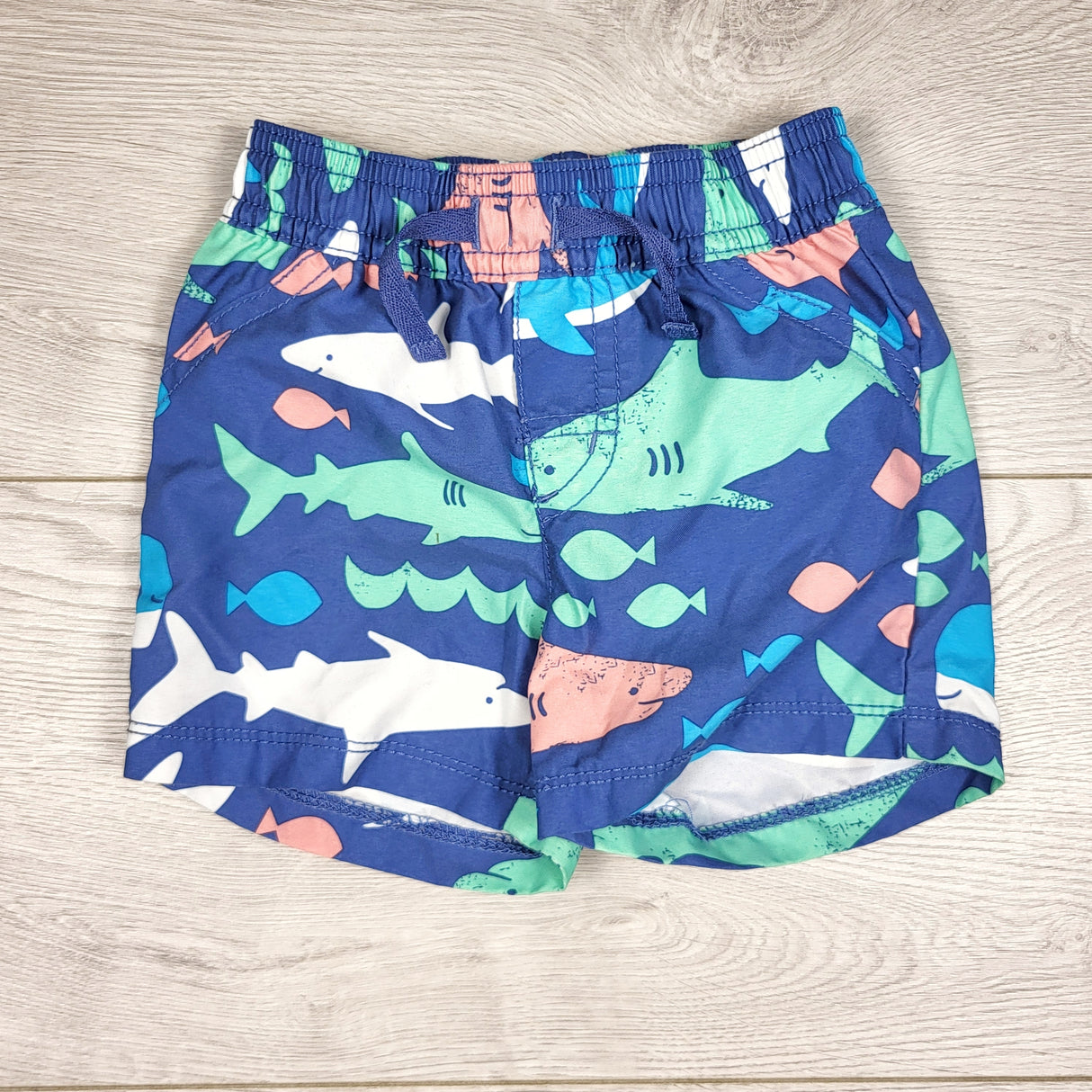 DMKY3 - Carters blue swim shorts with sharks. Size 9 months