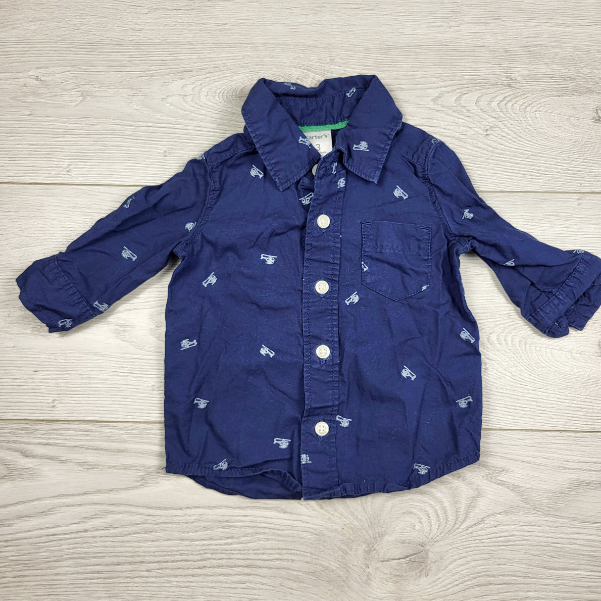 KARE11 - Carters navy button down shirt with helicopters. Size 3 months