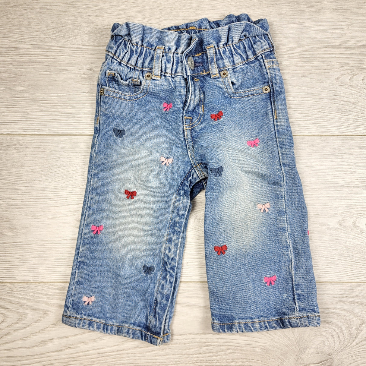 ORW1 - Gap distressed "Stride" jeans with bows. Size 12-18 months
