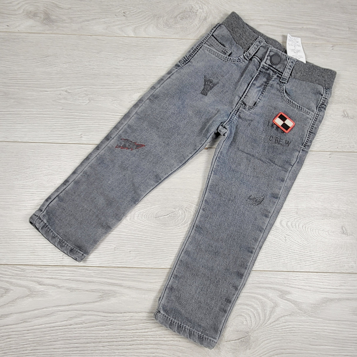 MCX1 - IKKS grey distressed pull on jeans with racing theme. Size 2T