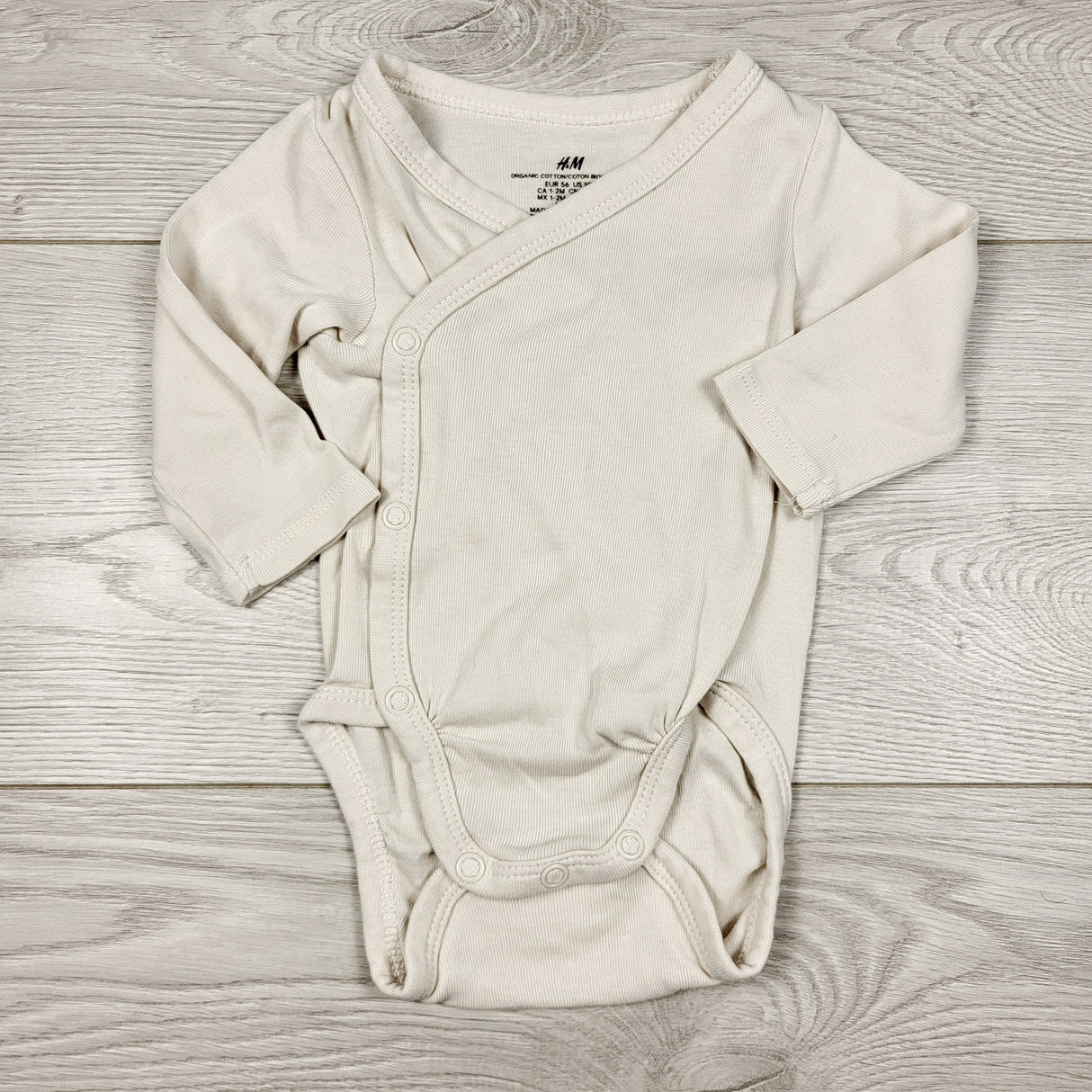RBEN1 - H and M beige organic cotton wrap style bodysuit. Size 1-2 months