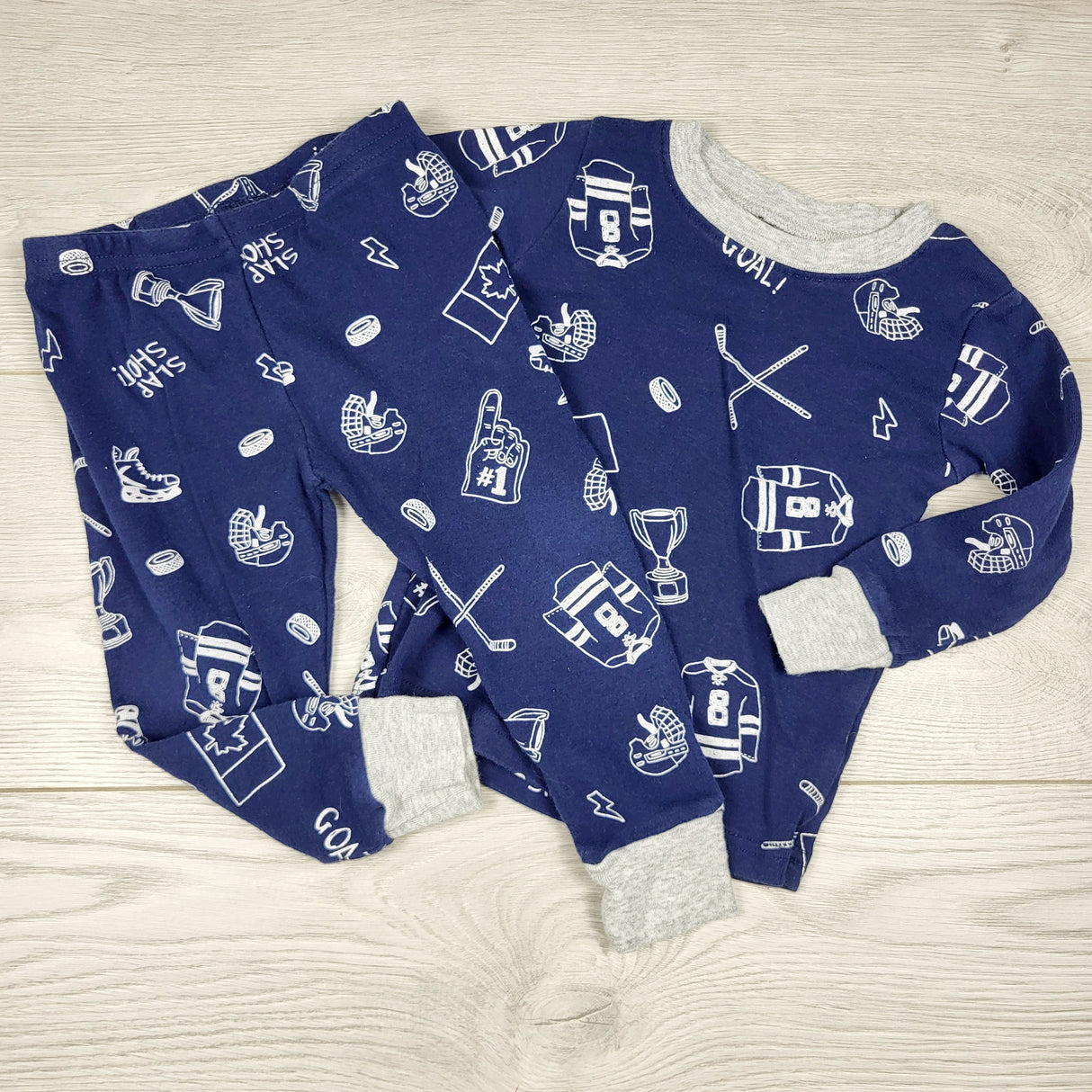 PTOM1 - Carters navy 2pc cotton PJs with hockey theme. Size 18 months