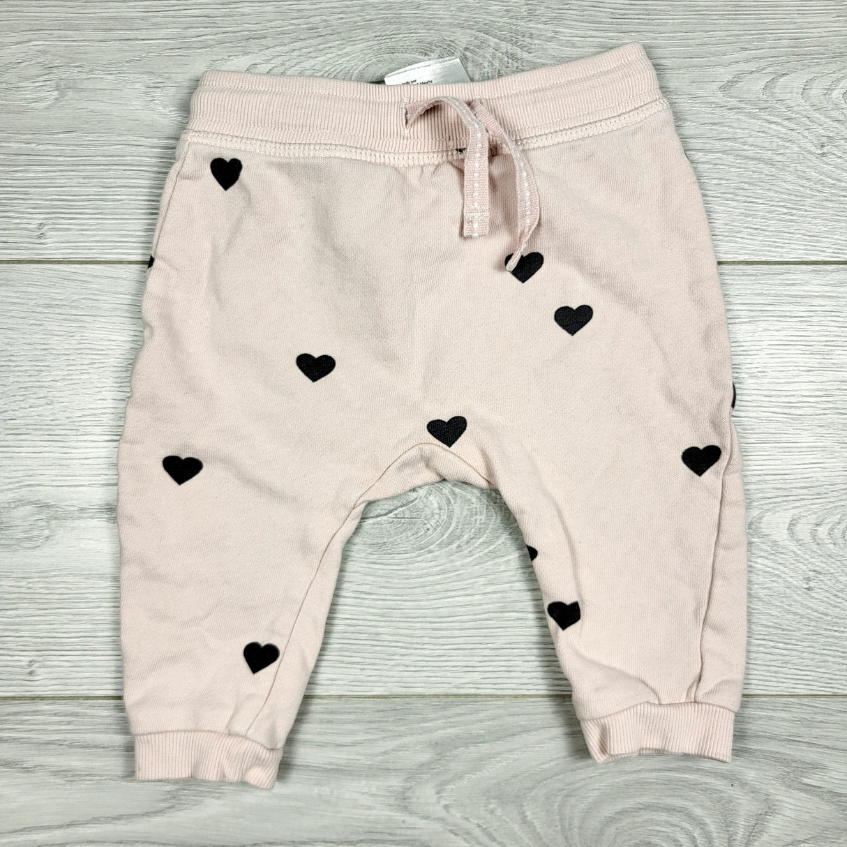 CCAM1 - H and M pink organic cotton joggers with hearts. Size 2-4 months