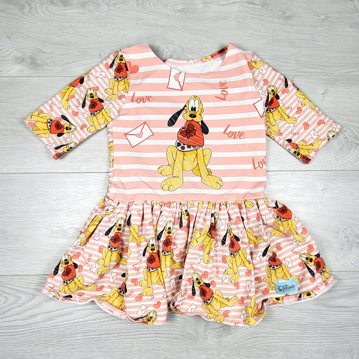 KTBL1 - Sweet Petunia Clothing pink striped peplum top with Pluto. Approz size 6/7
