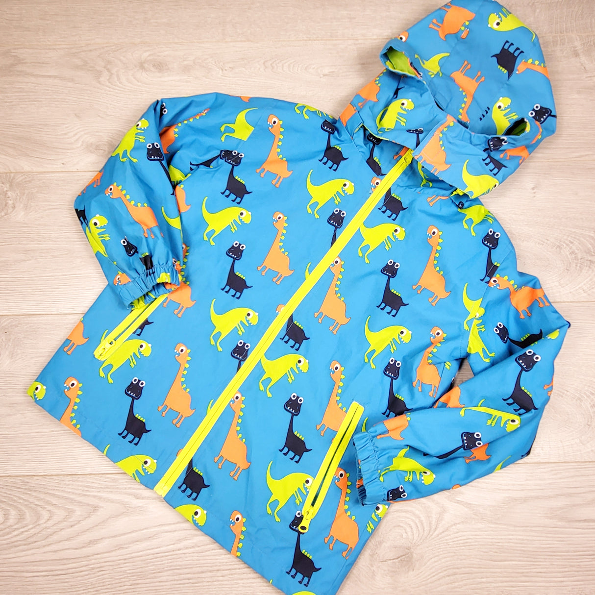 DPAR2 - Ljn Ubh blue dinosaur rain coat. Size 6-8 Years