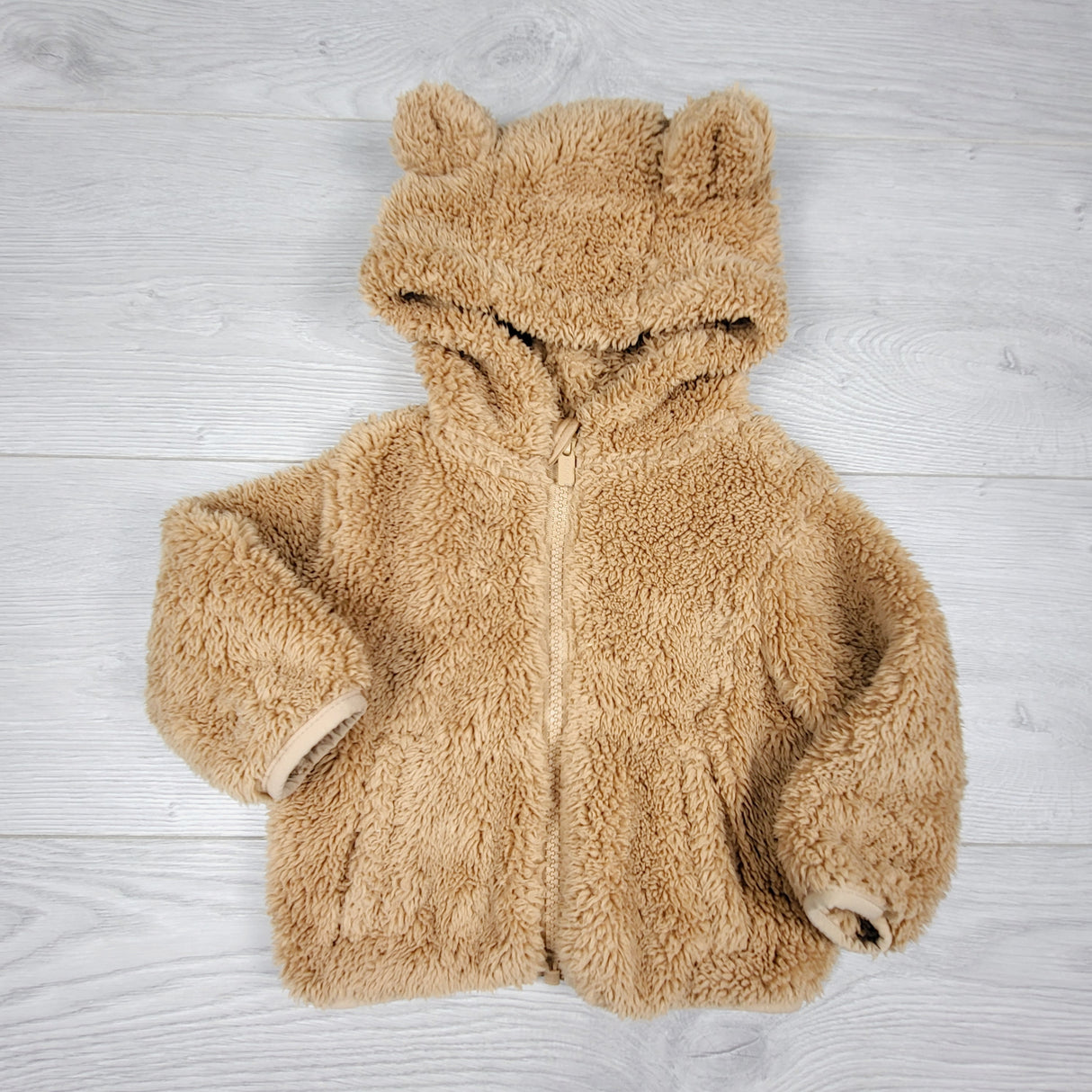 KAMG11 - Old Navy tan zip up bear ear hoodie. Size 3-6 months