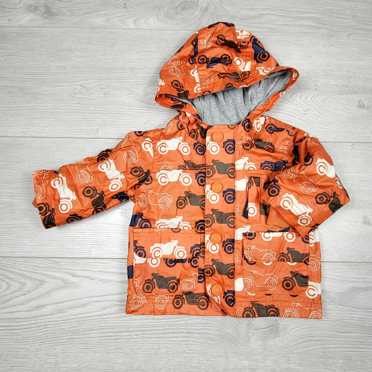 KRML1 - Gap orange rain jacket with motorcycles. Size 0-6 months