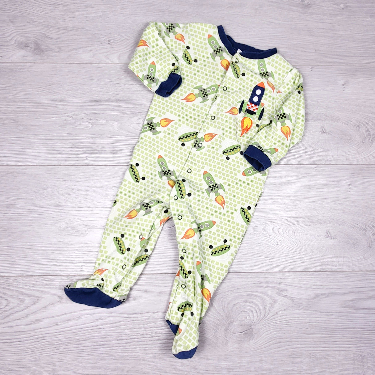 KRML1 - Pekkle green cotton sleeper with rockets. Size 9 months