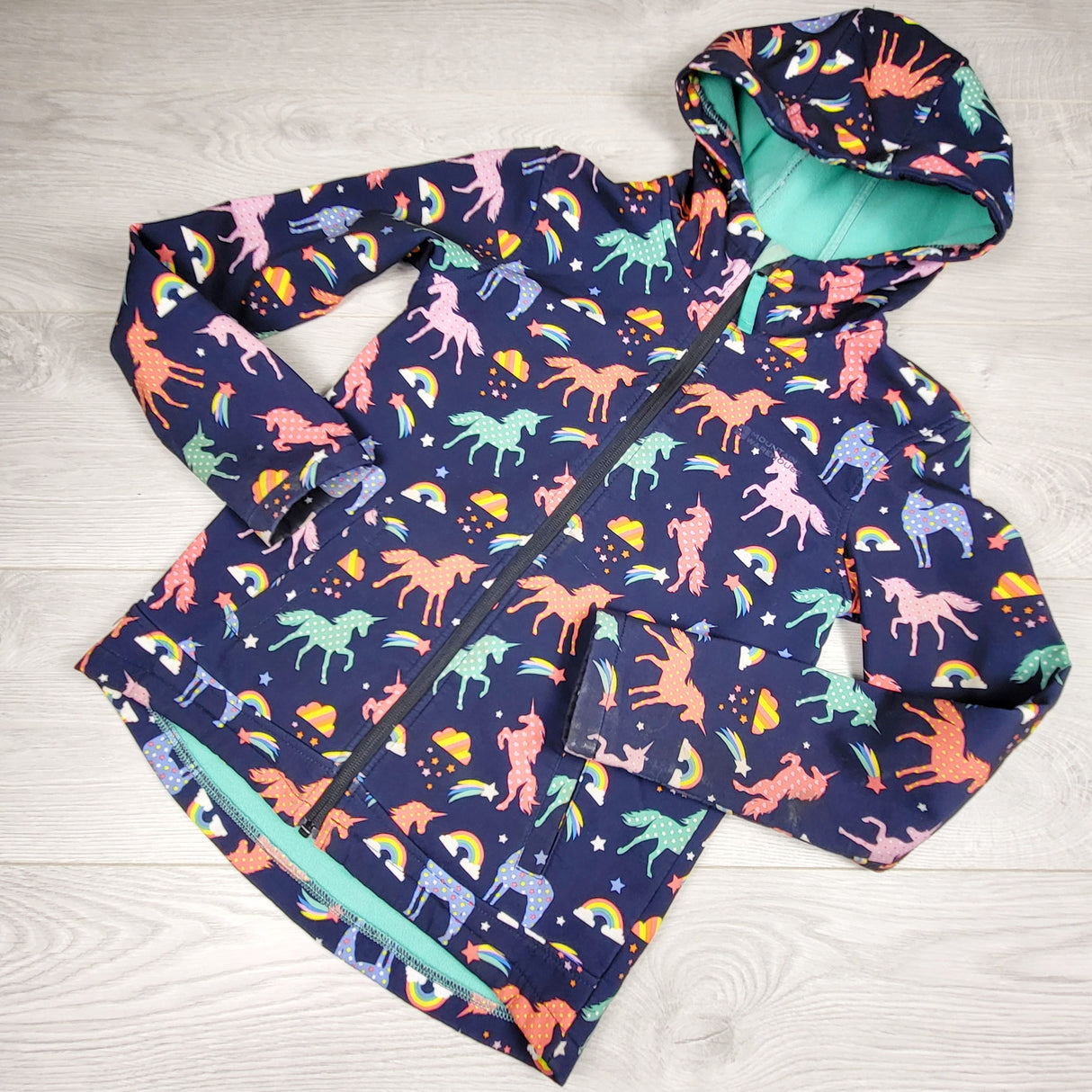 KSAL3 - Mountain Warehouse navy soft shell rain coat with unicorns. Size 9/10