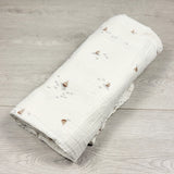 White muslin cotton swaddle with sailboats