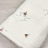 White muslin cotton swaddle with sailboats