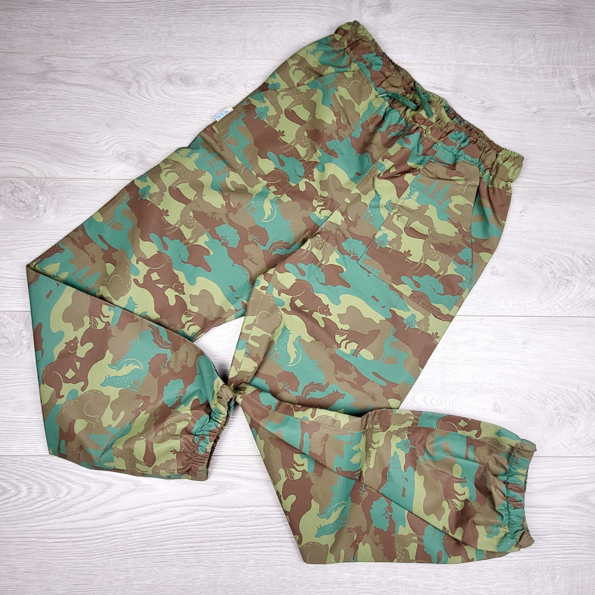 Jan and Jul camouflage single layer rain pants. Size like a 10