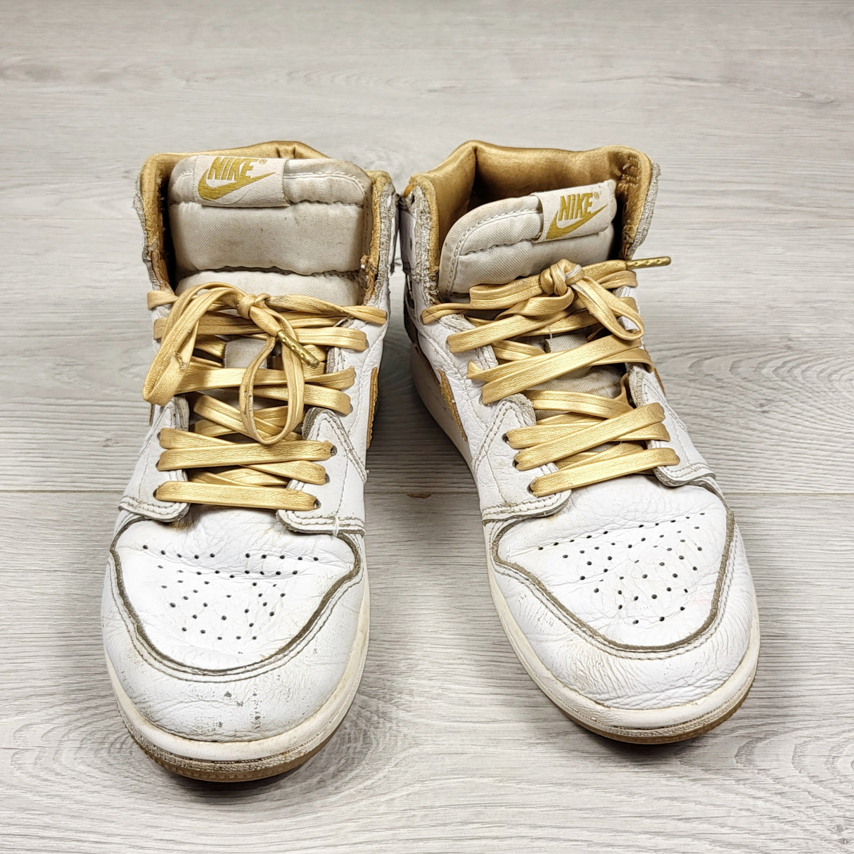 Nike white and gold retro Air Jordan 1 hightop sneakers. Youth size 2