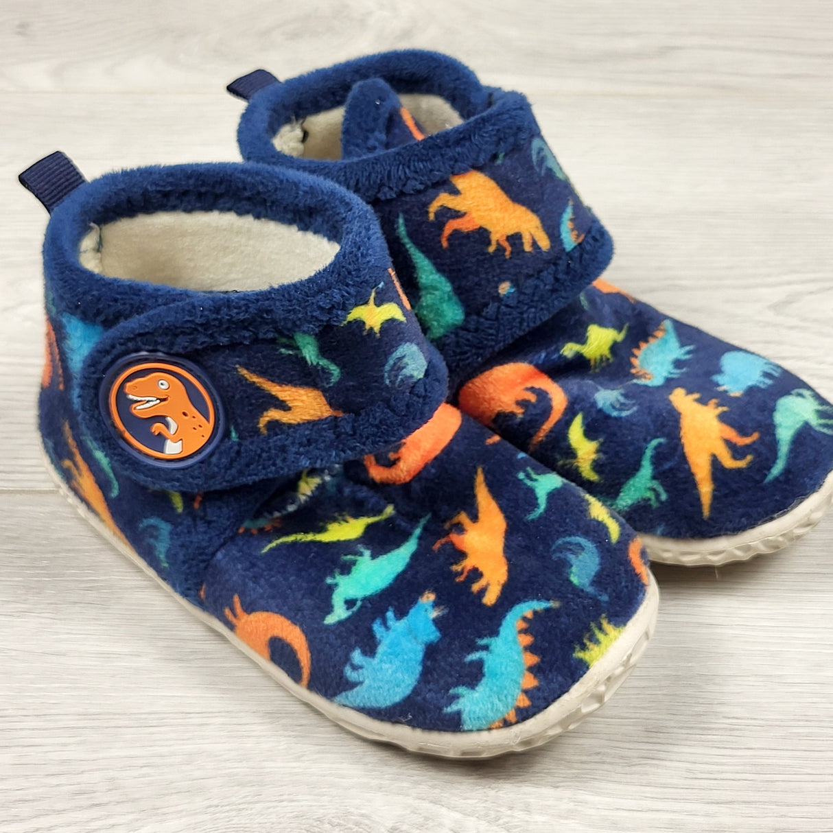 Navy plush dinosaur slippers with rubber soles. Size 9/10