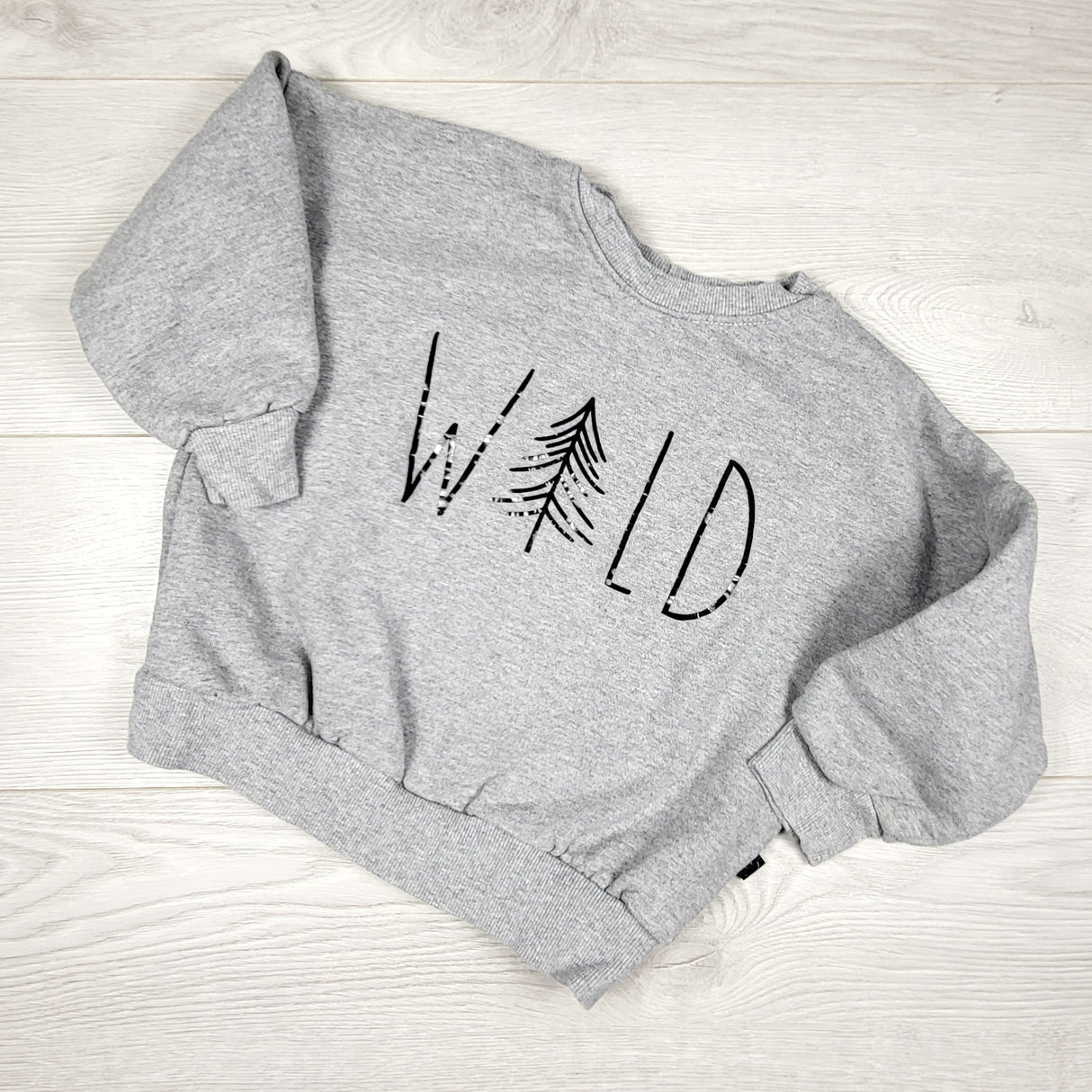 Grey custom "Wild" sweatshirt. Sizes like a 3/4T