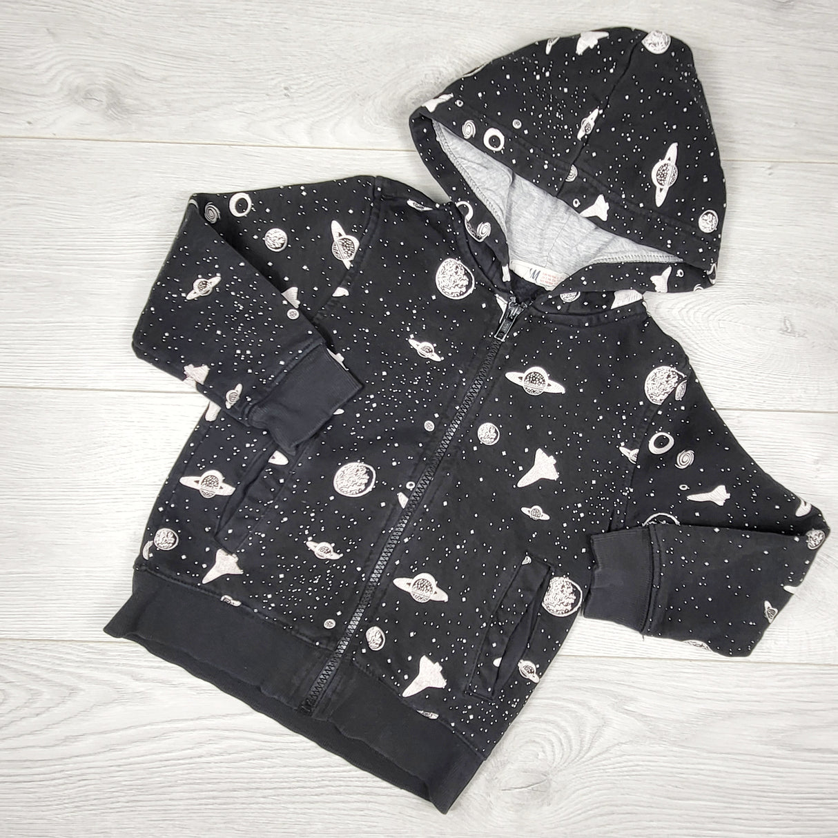 H and M black fleecy lined space themed zip up hoodie. Size 2-4T