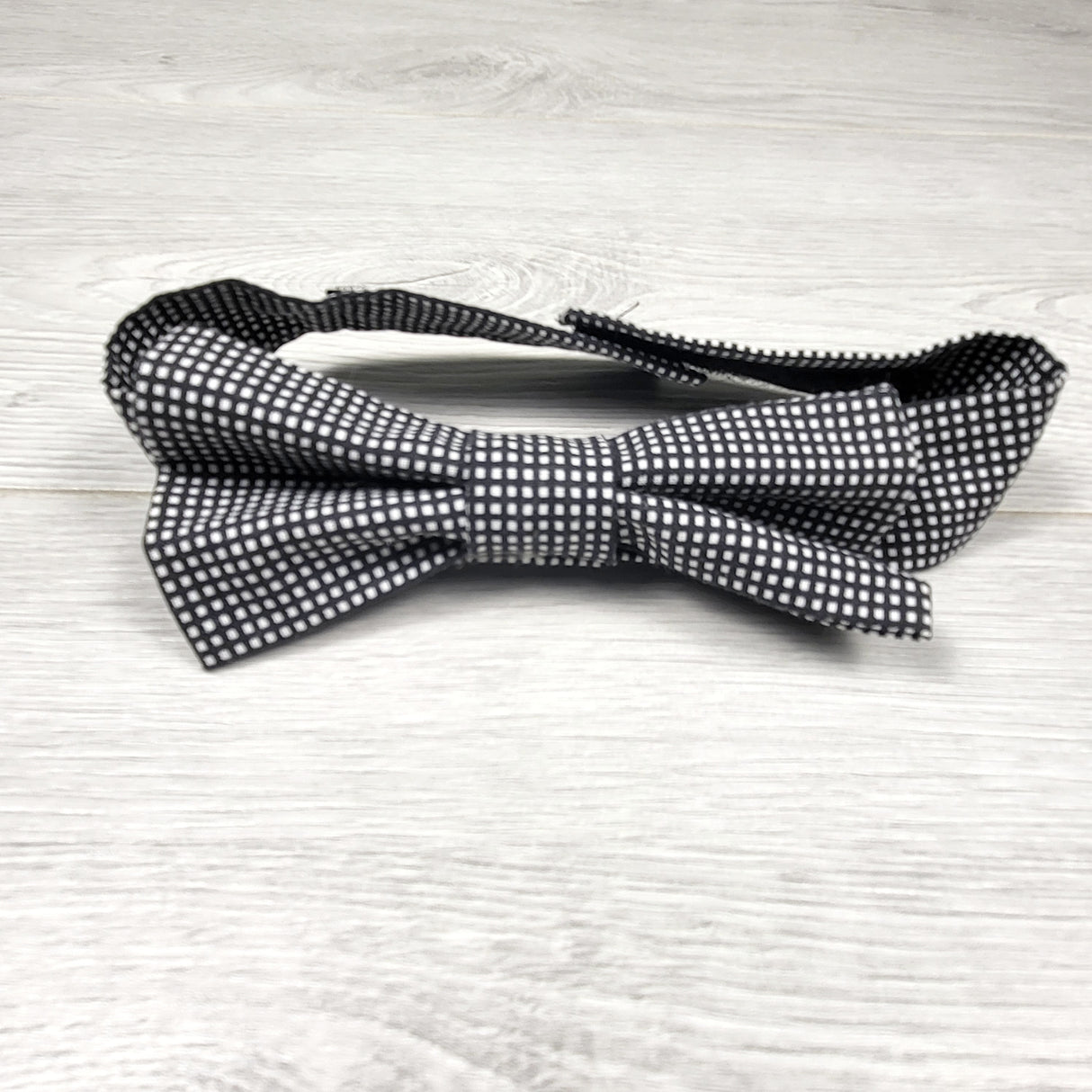 Handmade plaid bow tie with velcro closure.  One size fits all