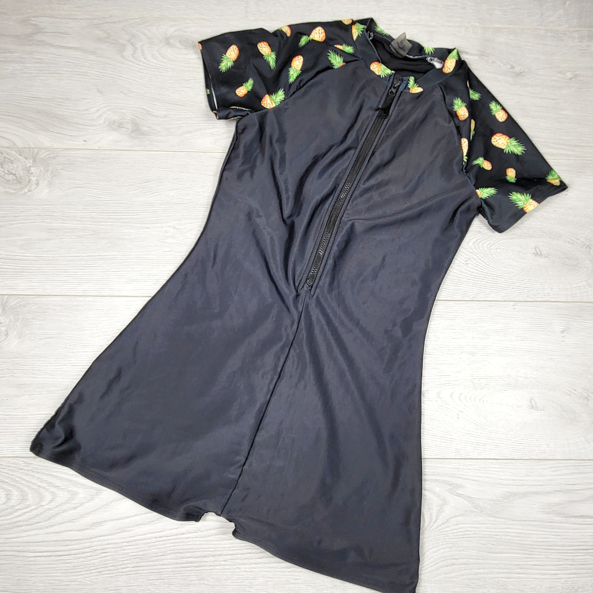 Old Navy black one piece rash gaurd with pineapples. Size 14/16