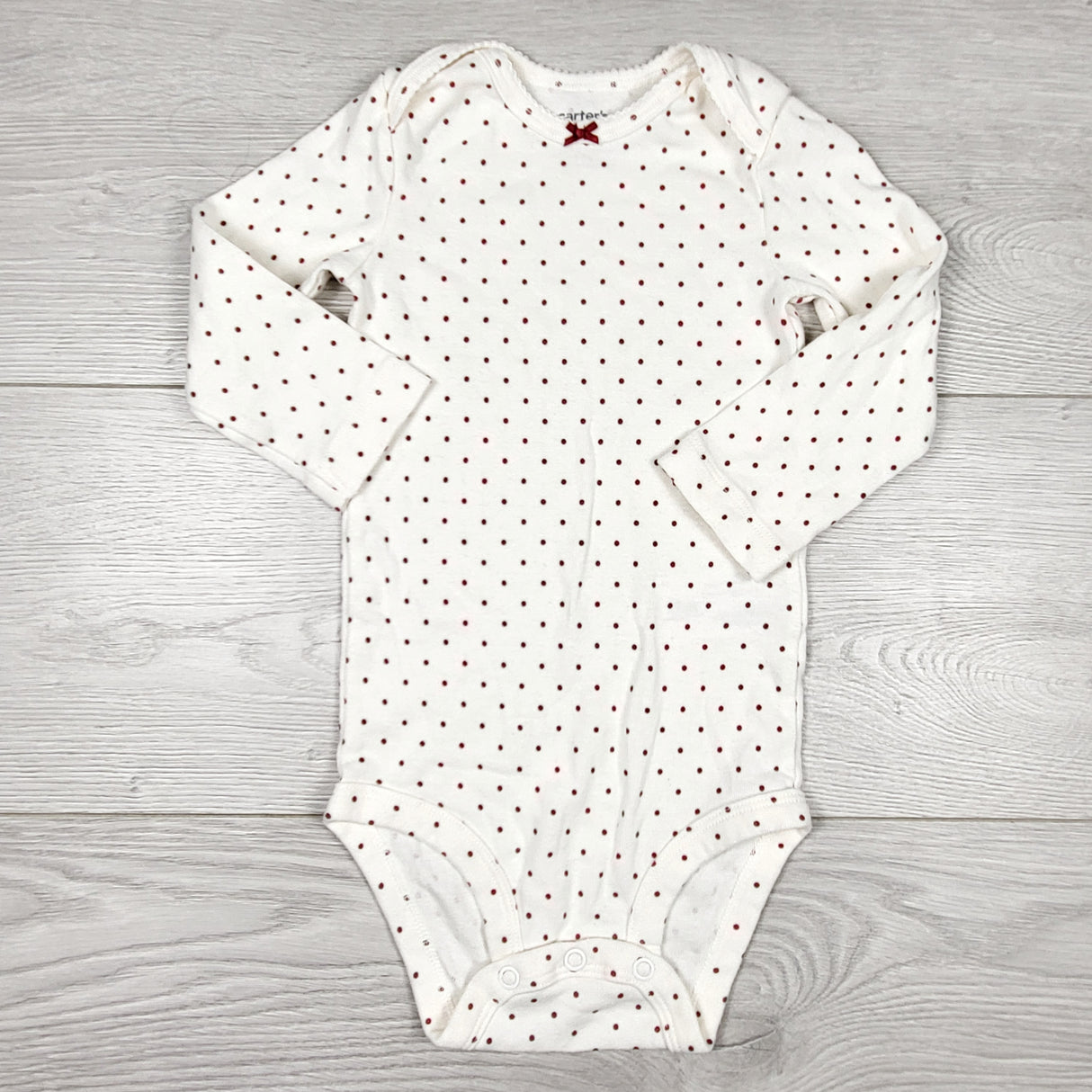 Carters cream coloured polka dot bodysuit. Size 12 months